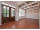 Formal dining room featuring hardwood floors, wainscoting, and a coffered ceiling at 6861 Ga Hwy 5, Douglasville, GA 30135