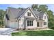 Stunning home featuring an attached three-car garage and lush green lawn at 6861 Ga Hwy 5, Douglasville, GA 30135