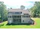 Back exterior view of home featuring a deck, patio, and wooded backdrop at 6861 Ga Hwy 5, Douglasville, GA 30135