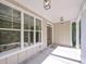 Charming front porch with stone accents, wooden door, and lantern lighting at 6861 Ga Hwy 5, Douglasville, GA 30135