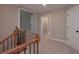 Upstairs hallway with carpet, doors, and a wooden and metal banister at 6861 Ga Hwy 5, Douglasville, GA 30135