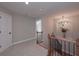 Bright hallway featuring a decorative chandelier and beautiful wood and iron banister at 6861 Ga Hwy 5, Douglasville, GA 30135