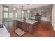 Modern kitchen island with stainless steel sink and hardwood floors with open access to the living room at 6861 Ga Hwy 5, Douglasville, GA 30135