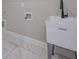 Laundry room featuring a utility sink, white cabinets, and tile flooring at 6861 Ga Hwy 5, Douglasville, GA 30135