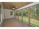 Spacious screened porch with wood-paneled ceiling, ceiling fan, and nature views at 6861 Ga Hwy 5, Douglasville, GA 30135