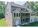 New construction shows a screened porch above the patio and a walkout basement on this light gray home at 6861 Ga Hwy 5, Douglasville, GA 30135