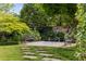 Lush backyard retreat with stone patio, benches, and a water feature at 1 Brookhaven Ne Dr # 205, Atlanta, GA 30319