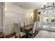 Dining room features a chandelier, paneling, and access to outdoor area at 1 Brookhaven Ne Dr # 205, Atlanta, GA 30319
