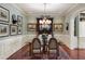 Formal dining room with elegant chandelier, wainscoting, and ample seating at 1 Brookhaven Ne Dr # 205, Atlanta, GA 30319