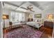 Serene bedroom with tray ceiling, shutters, and sitting area with bench at 1 Brookhaven Ne Dr # 205, Atlanta, GA 30319