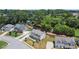 An aerial view of a neighborhood featuring a brick and siding two-story home surrounded by lush trees at 1620 Brook Ivy Dr, Lawrenceville, GA 30044