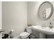 Cozy powder room features a pedestal sink, mirror, and tiled floors at 1620 Brook Ivy Dr, Lawrenceville, GA 30044