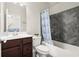 Modern bathroom with a bathtub and gray tiled walls at 1620 Brook Ivy Dr, Lawrenceville, GA 30044