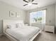 Bright bedroom features a large window with natural light and white furniture at 1620 Brook Ivy Dr, Lawrenceville, GA 30044