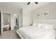 This bright bedroom features a ceiling fan, two framed pictures, and access to an ensuite bathroom at 1620 Brook Ivy Dr, Lawrenceville, GA 30044