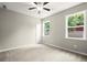 Well-lit bedroom with plush carpeting and large windows with outdoor views at 1620 Brook Ivy Dr, Lawrenceville, GA 30044