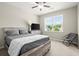 Cozy bedroom featuring a window with natural light and a comfortable chair at 1620 Brook Ivy Dr, Lawrenceville, GA 30044