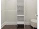 Clean walk-in closet with a wood rod and built-in shelving at 1620 Brook Ivy Dr, Lawrenceville, GA 30044