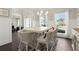 An elegant dining area featuring an open design, large windows, and stylish furnishings at 1620 Brook Ivy Dr, Lawrenceville, GA 30044