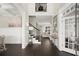 Inviting entryway with gleaming hardwood floors, staircase, and views into the living area at 1620 Brook Ivy Dr, Lawrenceville, GA 30044