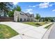 Stately home features a brick and siding exterior, long driveway, and beautifully landscaped front yard at 1620 Brook Ivy Dr, Lawrenceville, GA 30044