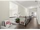 Upstairs hallway boasts wood floors, dark railing, and doorway to bedrooms at 1620 Brook Ivy Dr, Lawrenceville, GA 30044