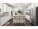 Open-concept kitchen featuring stainless steel appliances, an island, and a view to the living room at 1620 Brook Ivy Dr, Lawrenceville, GA 30044