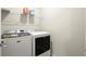 Modern laundry room with front-load washer and dryer and upper shelf storage at 1620 Brook Ivy Dr, Lawrenceville, GA 30044