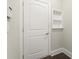 Bright mud room features storage hooks with cubby shelf and a white paneled door at 1620 Brook Ivy Dr, Lawrenceville, GA 30044