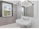Modern bathroom with tiled walls, stylish fixtures, and natural light from the window at 2776 Grand Ave, Atlanta, GA 30315