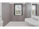 Modern bathroom with tiled walls, stylish fixtures, and natural light from the window at 2776 Grand Ave, Atlanta, GA 30315