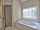 Bathroom features a soaking tub with a stained-glass window and a glass-enclosed shower at 4221 Bretdale Nw Run, Kennesaw, GA 30152