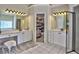 Spacious bathroom with dual sinks, white cabinets, a makeup vanity, a toilet and a glass-enclosed shower at 4221 Bretdale Nw Run, Kennesaw, GA 30152