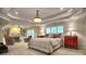 Large bedroom with a tray ceiling, a ceiling fan, two seating areas, and natural light at 4221 Bretdale Nw Run, Kennesaw, GA 30152