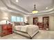 Spacious bedroom with tray ceilings, a large window, two dressers and built-in bookshelves at 4221 Bretdale Nw Run, Kennesaw, GA 30152