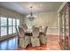 Formal dining room featuring a round table, patterned chairs, and natural light from the windows at 4221 Bretdale Nw Run, Kennesaw, GA 30152