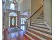 Inviting foyer with hardwood floors, a staircase, and a decorative front door with sidelights at 4221 Bretdale Nw Run, Kennesaw, GA 30152