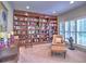 Cozy library with built-in bookshelves, plantation shutters, and comfortable seating at 4221 Bretdale Nw Run, Kennesaw, GA 30152