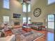 Bright living room with high ceilings, a fireplace, and large windows with plantation shutters at 4221 Bretdale Nw Run, Kennesaw, GA 30152
