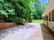 Spacious brick patio with outdoor fireplace and well-maintained landscaping at 4221 Bretdale Nw Run, Kennesaw, GA 30152