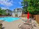 Community pool with lounge chairs, umbrella, and a large sundeck for relaxing at 4221 Bretdale Nw Run, Kennesaw, GA 30152