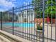 Community pool with fence, lounge chairs, umbrella, and a nearby apartment building at 4221 Bretdale Nw Run, Kennesaw, GA 30152
