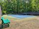 Community tennis court surrounded by lush greenery and seating for players and spectators at 4221 Bretdale Nw Run, Kennesaw, GA 30152