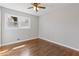 Bright bedroom featuring hardwood floors, large window and a ceiling fan at 5277 Cardinal Nw Ln, Lilburn, GA 30047