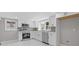 Bright kitchen featuring white cabinets, stainless steel appliances, and stone tile backsplash at 5277 Cardinal Nw Ln, Lilburn, GA 30047
