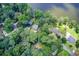Aerial view of lakefront homes surrounded by lush trees, showcasing a serene and private setting at 8531 Lake Dr, Snellville, GA 30039