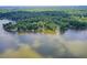 Breathtaking aerial view showcases lakefront homes surrounded by lush trees, offering serene waterfront living at 8531 Lake Dr, Snellville, GA 30039