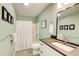 Bathroom with tiled floors and shower/tub, plus a light green wall at 8531 Lake Dr, Snellville, GA 30039