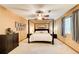 Spacious bedroom with a four-poster bed, ceiling fan, and carpeted floors at 8531 Lake Dr, Snellville, GA 30039