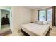 Bedroom with closet and window next to the bathroom with a rug at 8531 Lake Dr, Snellville, GA 30039